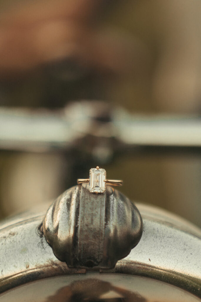 Engagement ring balances on bike rim.