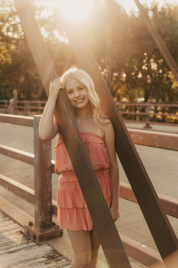 Senior photos Minneapolis with blonde high school girl wearing coral sundress