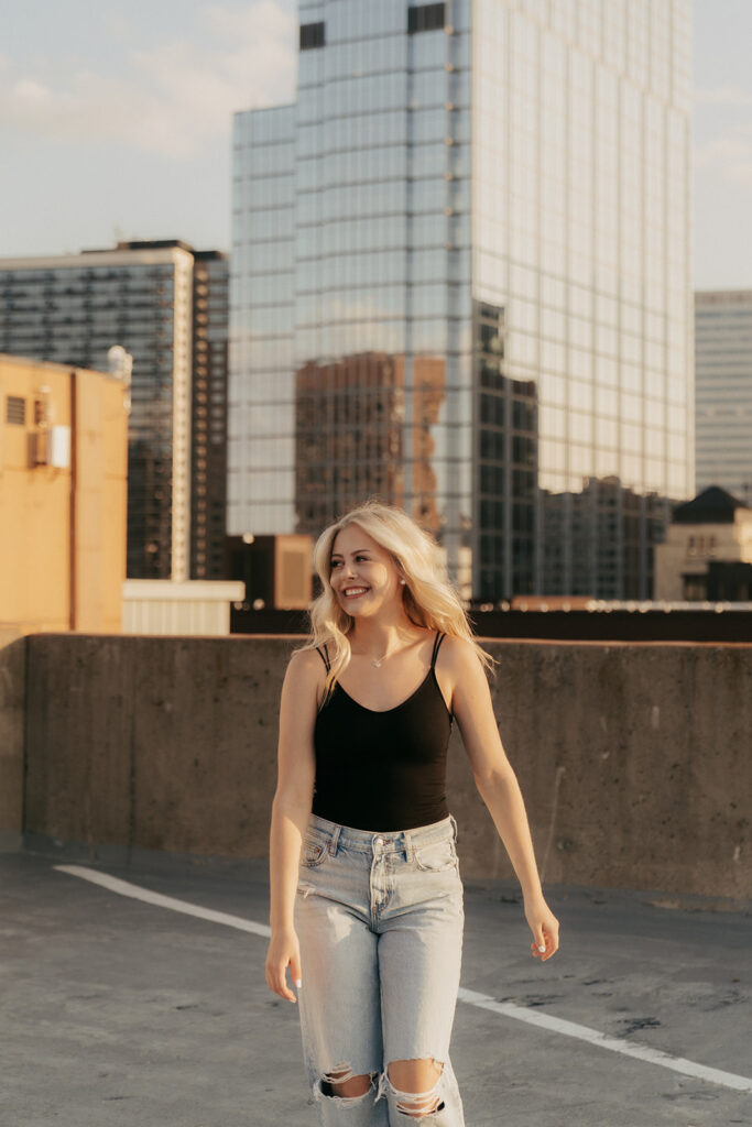 Senior photos in Minneapolis on rooftop overlooking city skyline