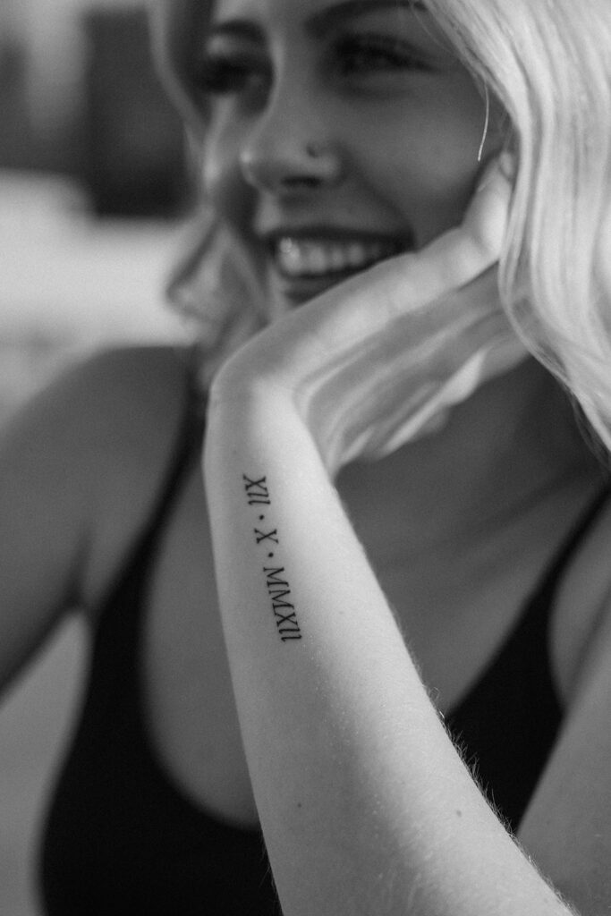 Roman numeral tattoo on girl's arm during senior photos in Minneapolis