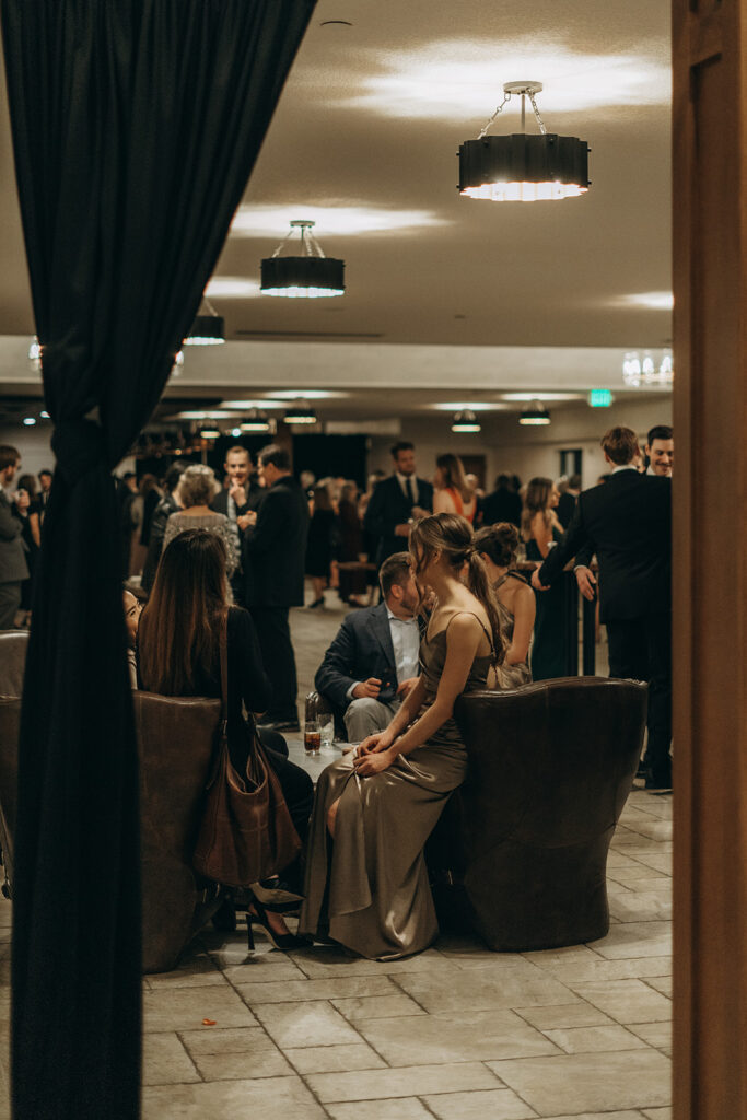 Candid cocktail hour at Equestria West, with guests mingling and soft lighting casting a warm evening glow.