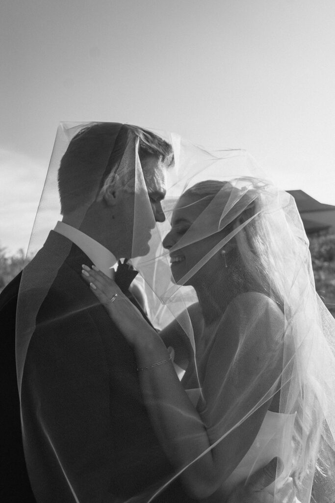 Bride laughs into groom's chest in November wedding in Minnesota.