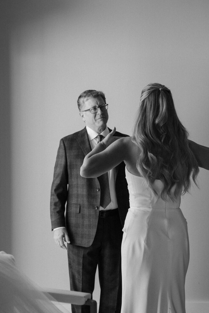 The bride surprises her father during a quiet first look before the candlelit ceremony at Equestria West.
