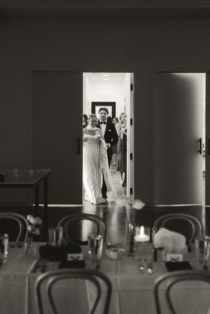 Bride and groom enter wedding reception space to see how it has all come to life