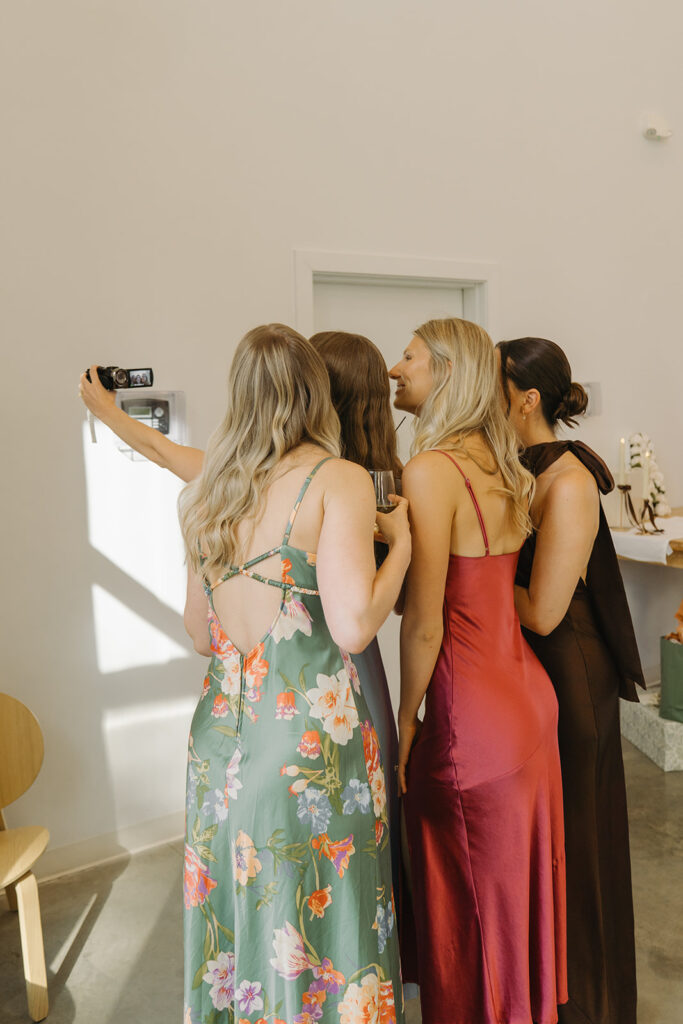 Wedding guests film a message for the bride and groom on camcorder