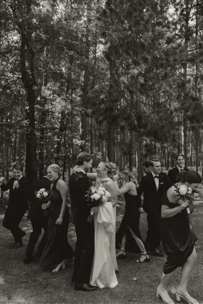 Bridal party whips around bride and groom