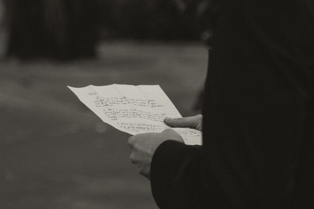 Handwritten vows clutched by the groom during their emotional Minnesota elopement.