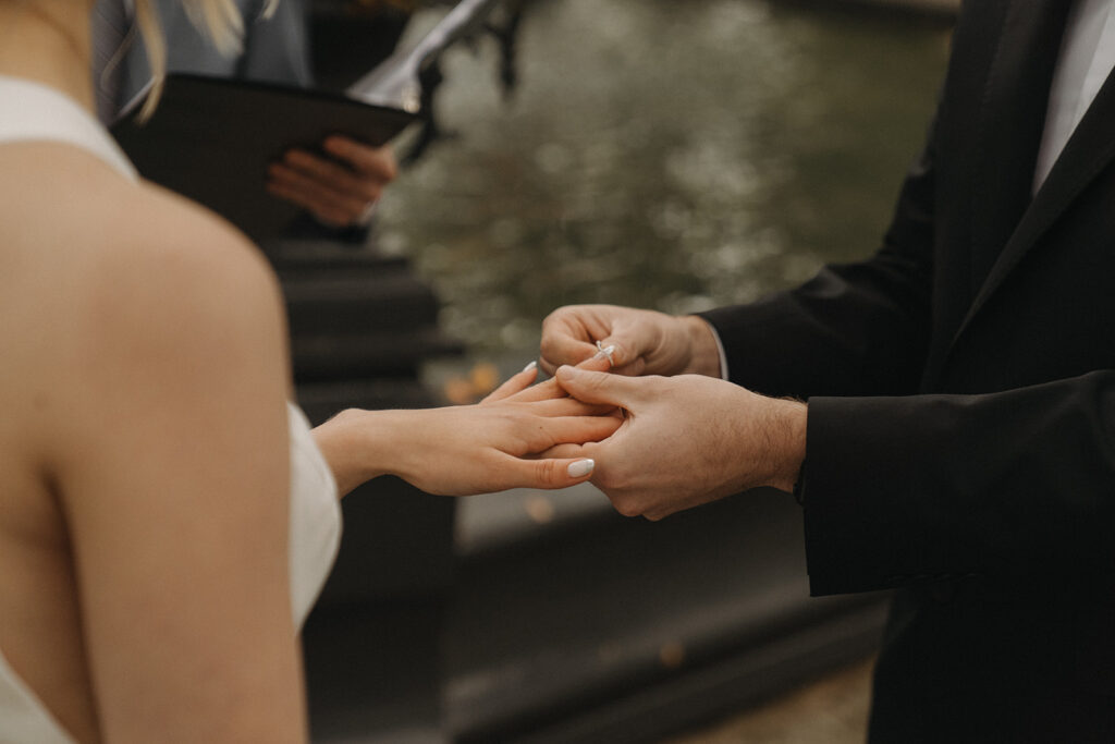 Groom takes bride’s hands during their vow exchange at their Minnesota elopement.