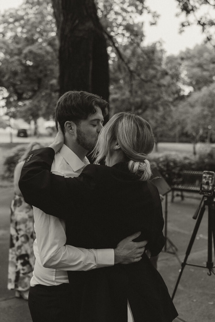 Couple embracing under the trees during their Irvine Park wedding day.