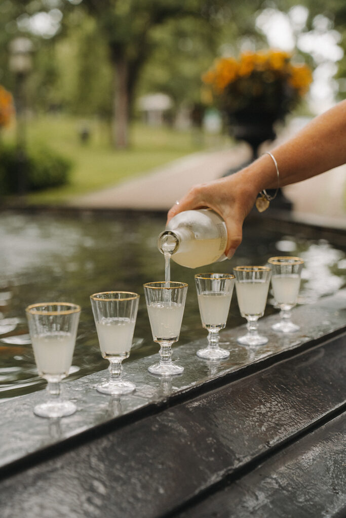 Lemon-drop shots lined up by the fountain for the Irvine Park wedding toast.