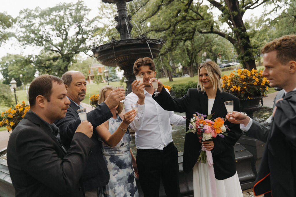 Wedding guests raise lemon-drop shots in a toast during this intimate Irvine Park wedding.