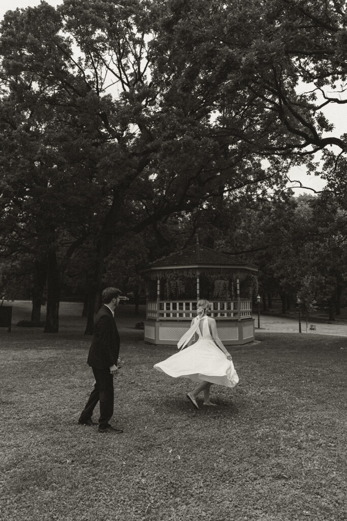 Groom twirls bride in black and white elopement photos at Irvine Park.