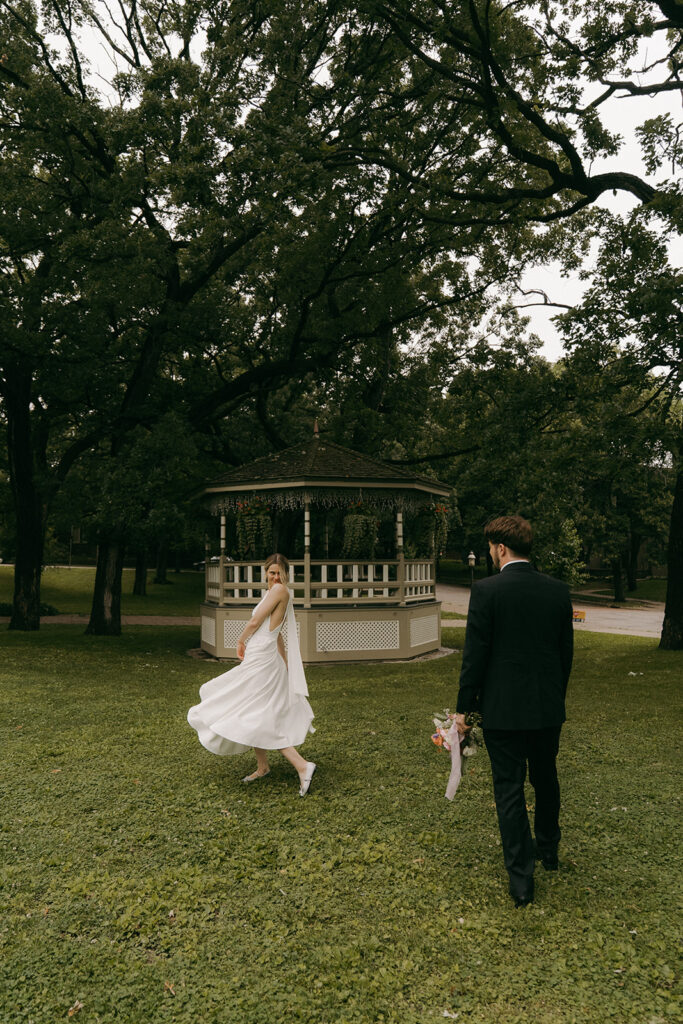 Bride and groom walkj through Irvine Park after their wedding vows.