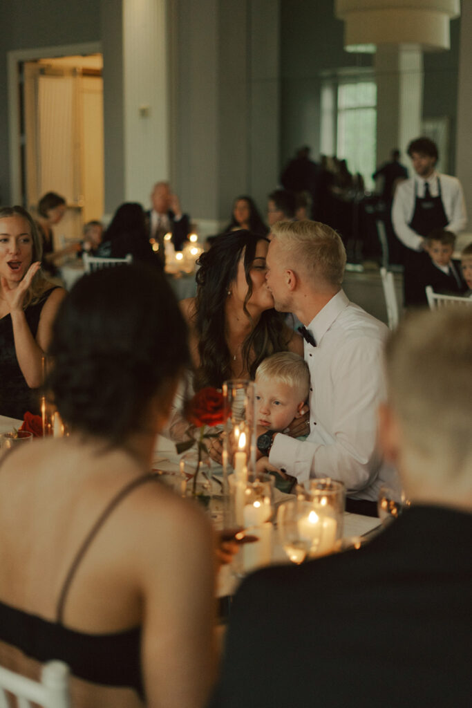 Bride and groom sharing a quiet moment during their elegant black-tie wedding dinner in St. Paul.