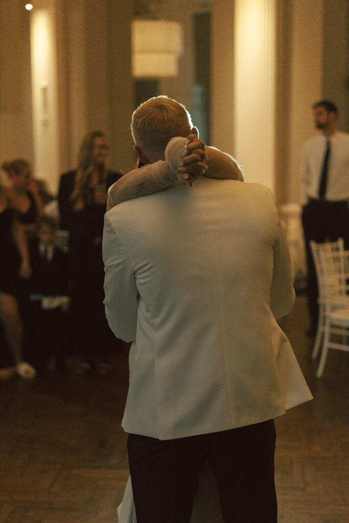 Groom hugging his bride during their first dance at a classy wedding in the Twin Cities.