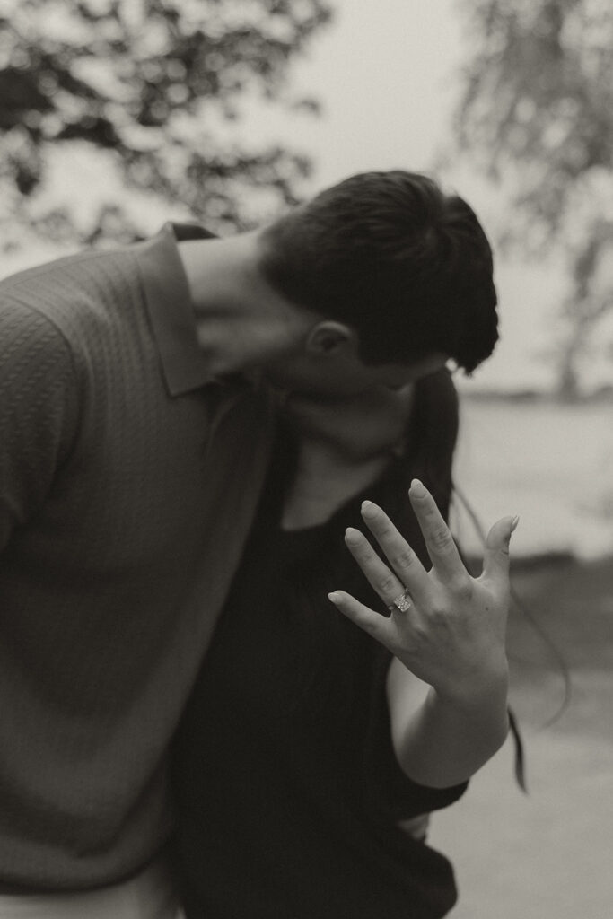 The couple sharing a kiss while Bella holds up her hand to show off the new engagement ring.