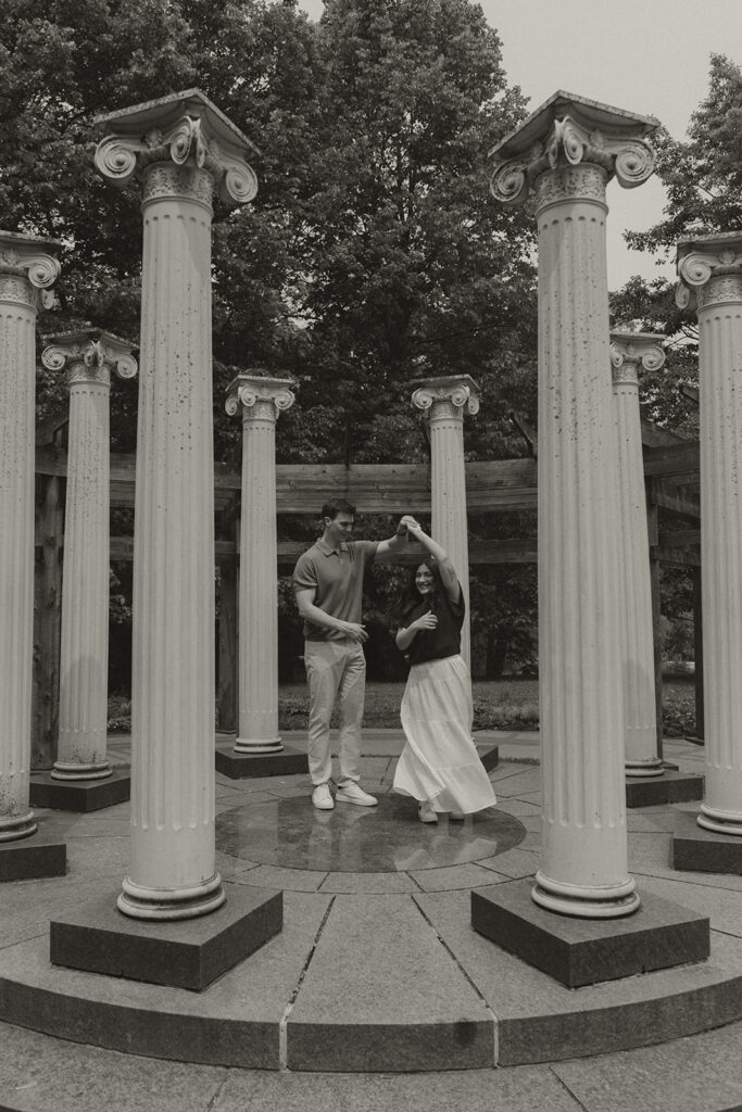 The couple sharing a dance in the center of the circular stone column structure at Noerenberg Gardens.
