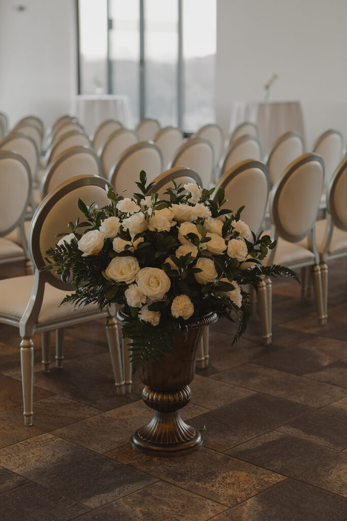 White roses in brown vase at Edward Anne Estate vintage wedding ceremony