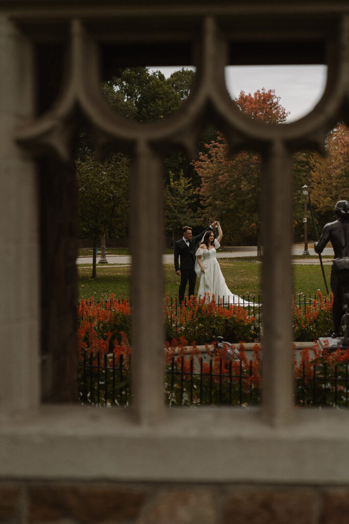 Bride and groom twirl in Saint Paul park before their vintage wedding