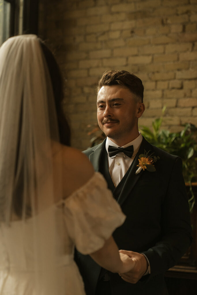 Groom looks at his bride with total adoration as they exchange their vows