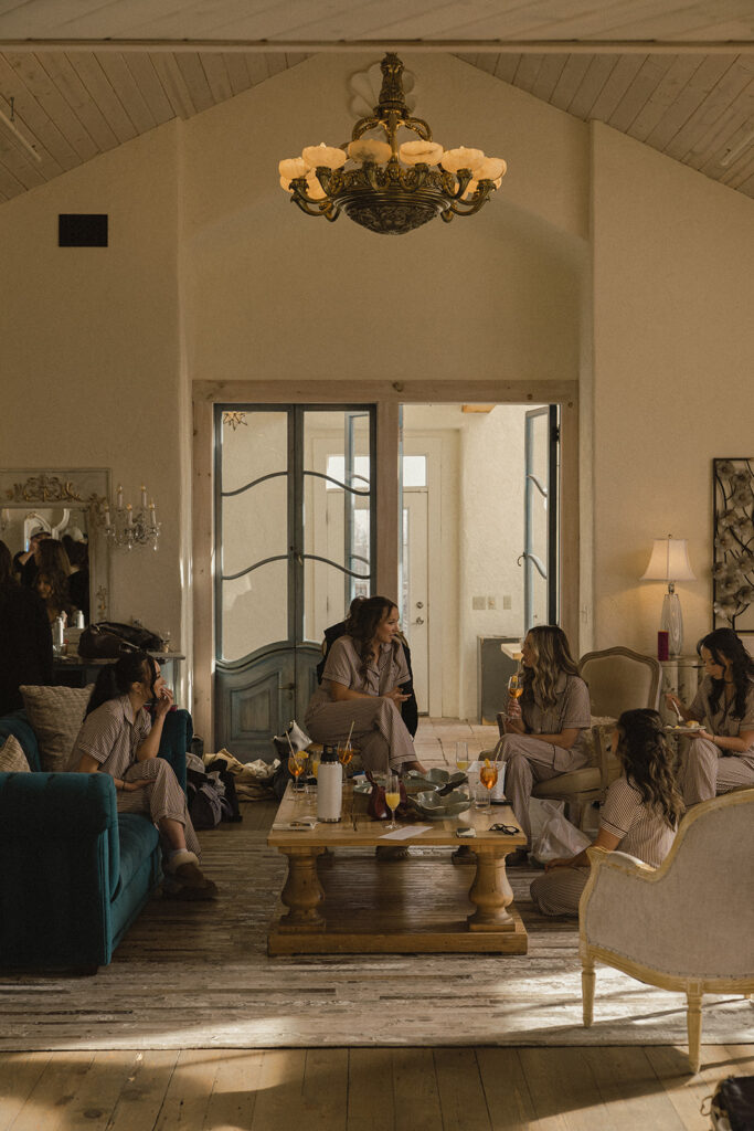 Bridal suite at Edward Anne Estate abuzz with activity as bridesmaids sit around in pajamas chatting