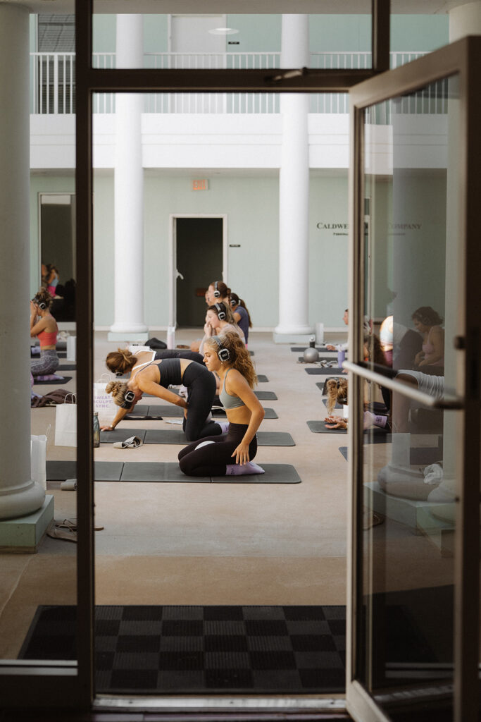 View through open doorway into Garnuu workout event, documentary-style branding photos.
