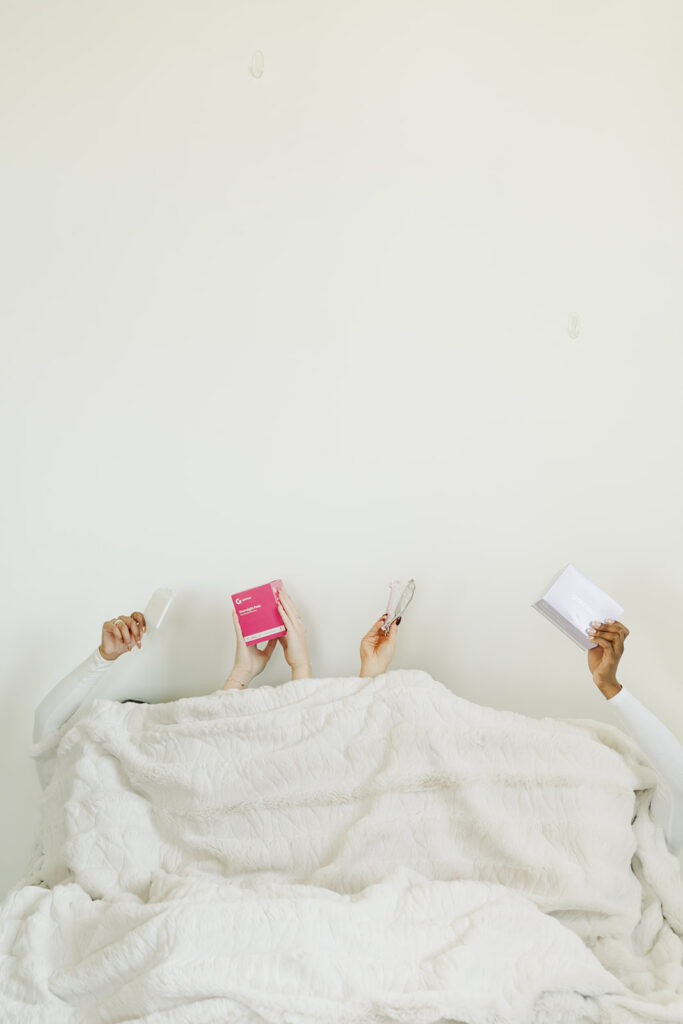 Hands holding Garnuu products and holiday gifts under cozy white blankets, festive branding photos.