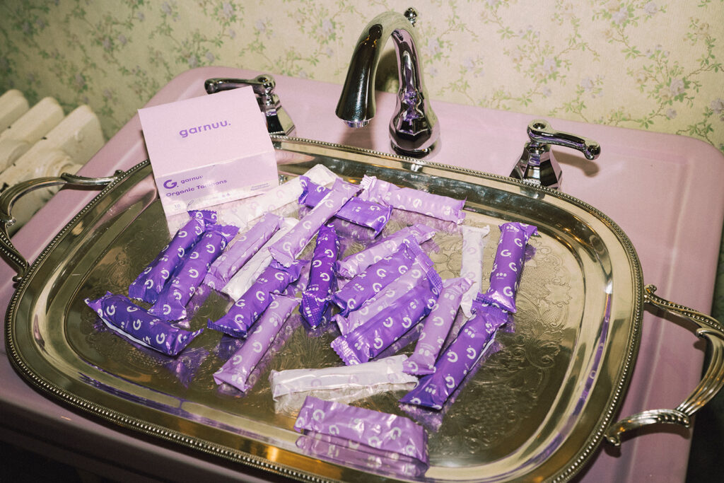 Silver tray filled with Garnuu products on a pink sink, polished product branding photos for Garnuu.