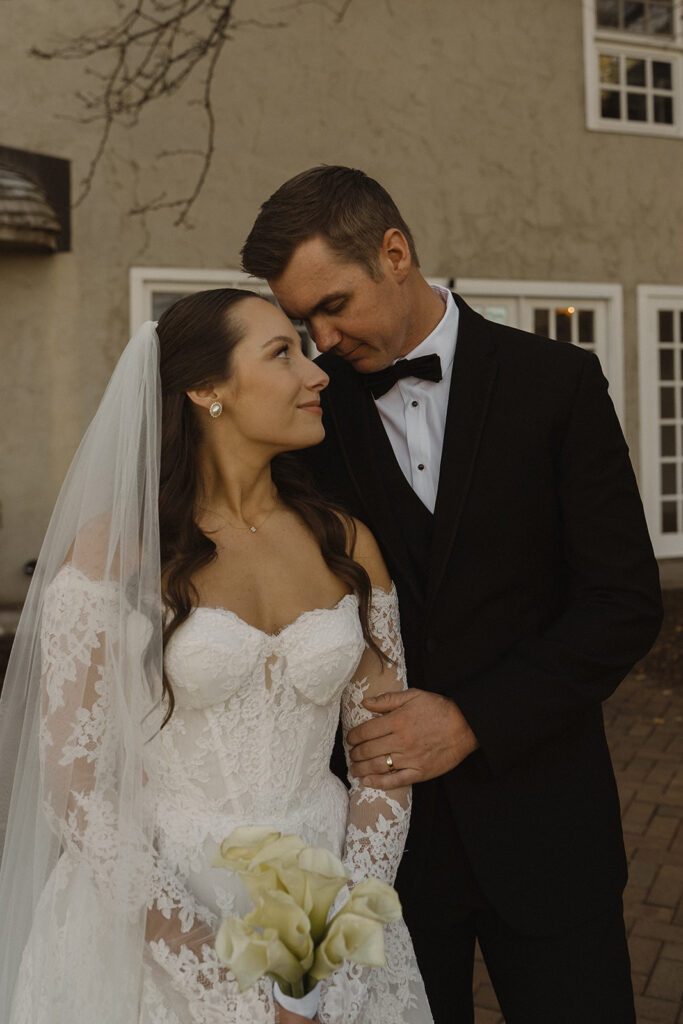 Bride and groom touch foreheads in soft, romantic portrait at historic wedding venue, Edward Anne Estate