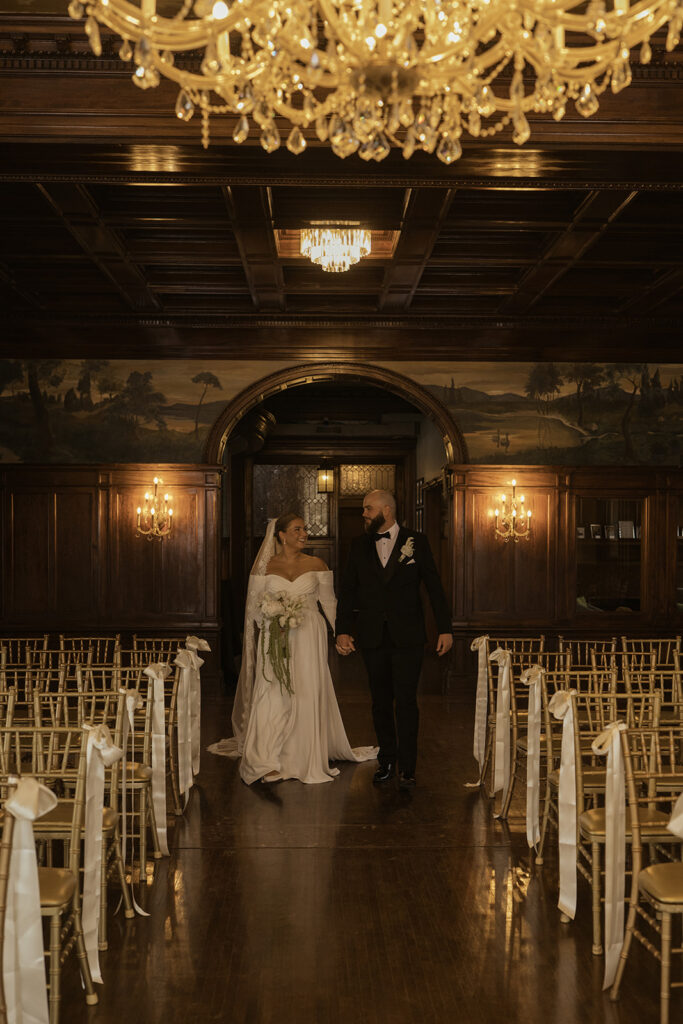 Ceremony space at Semple Mansion, complete with ornate woodwork, glittering chandelier, and beautiful paintings