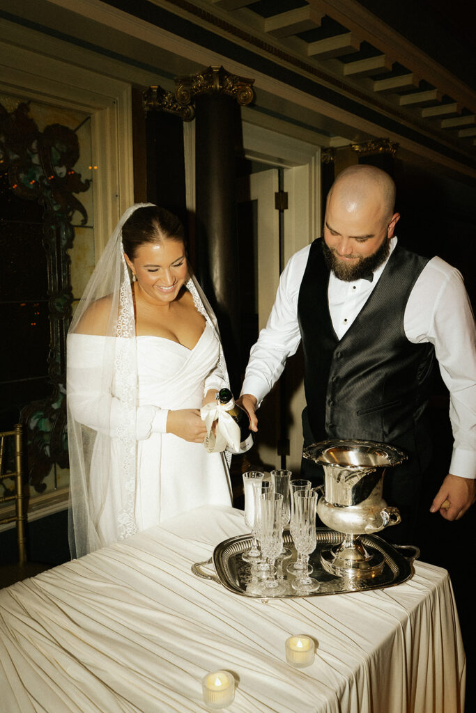 Bride and groom replace the traditional cake cutting at wedding with an elegant champagne pour at Semple Mansion affair