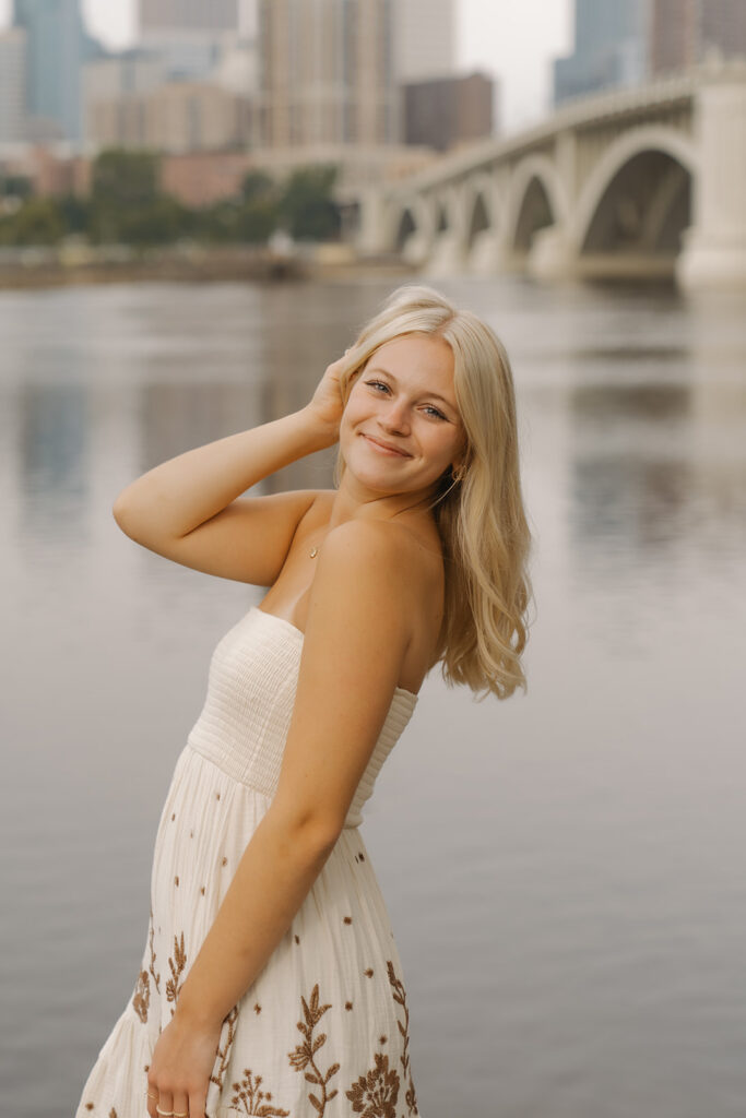Minneapolis senior photos with girl wearing white dress with brown flowers