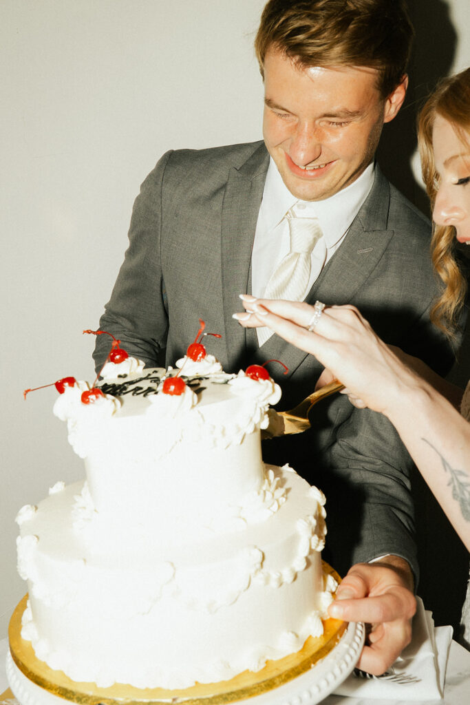 Vintage wedding cake ideas of 90s-inspired white wedding cake topped with cherries