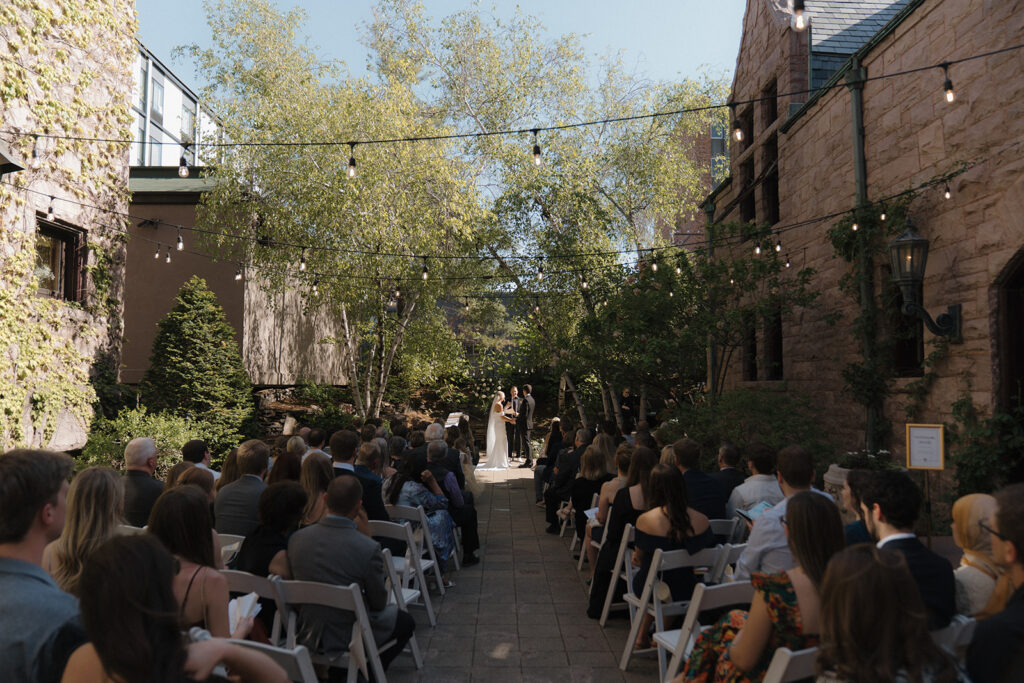 Intimate wedding ceremony in courtyard of Van Dusen Mansion