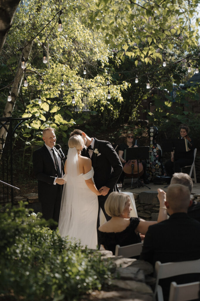 Newlyweds share first kiss as husband and wife at Van Dusen Mansion in Minneapolis, Minnesota